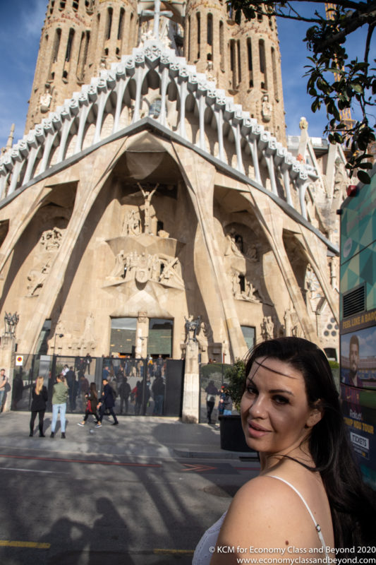 a woman posing for a picture in front of a building