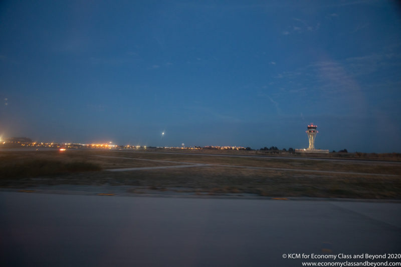 a runway with a tower in the distance
