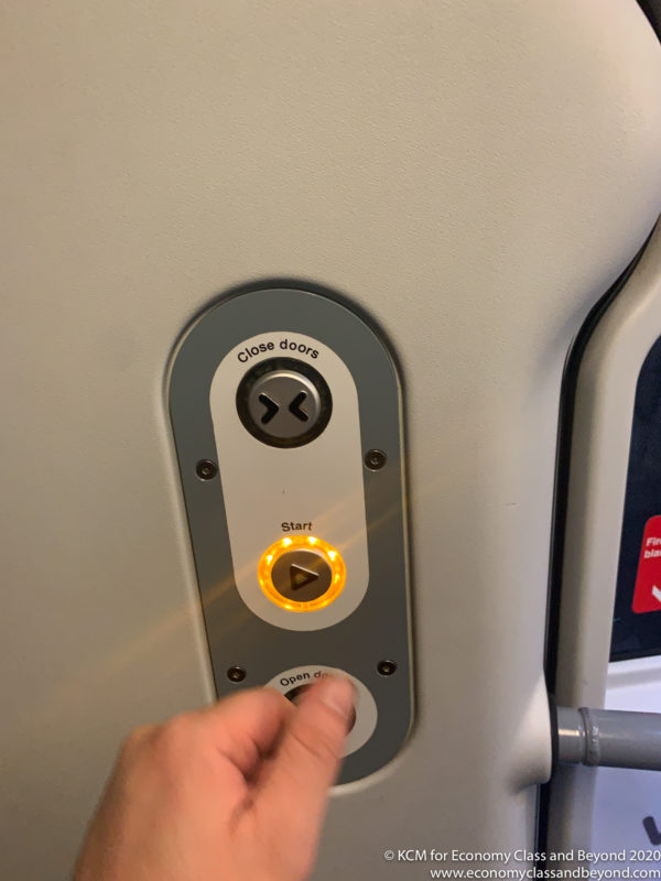 a hand pushing a button on a door