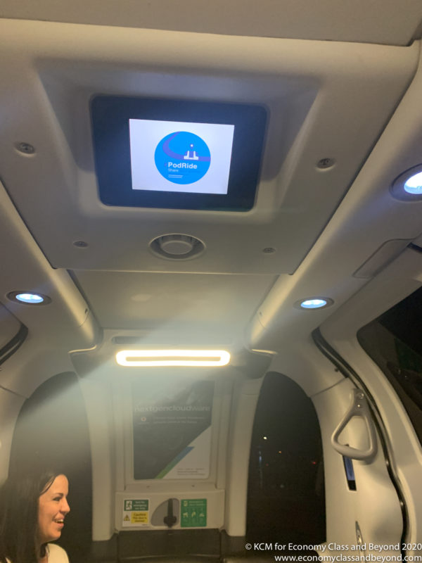 a screen on the ceiling of a vehicle