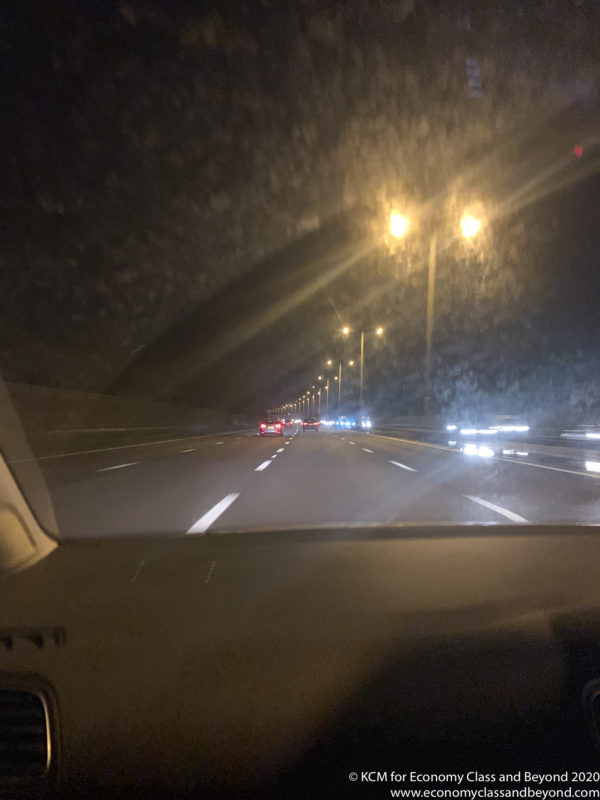 a view from inside a car of a road at night