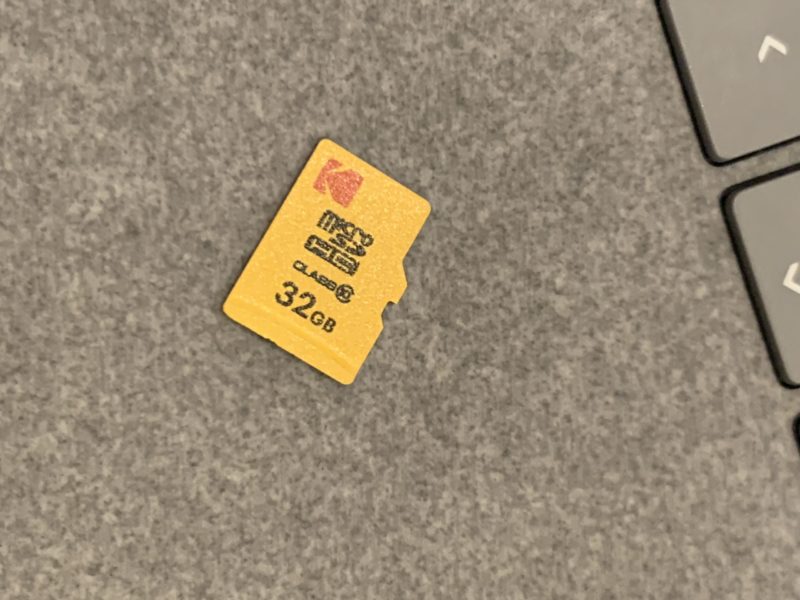 a yellow memory card on a grey surface