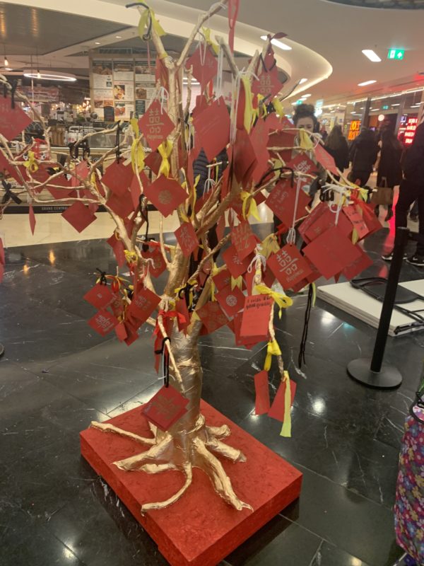 a tree with red cards and ribbons