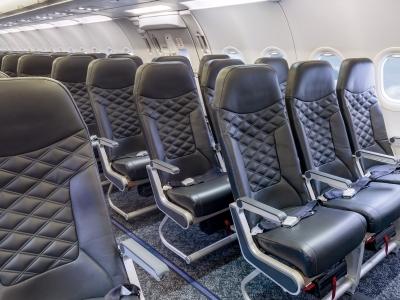 a row of black seats in an airplane