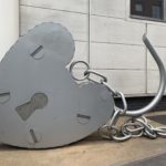 a large metal heart shaped object with a chain