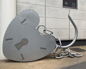 a large metal heart shaped object with a chain