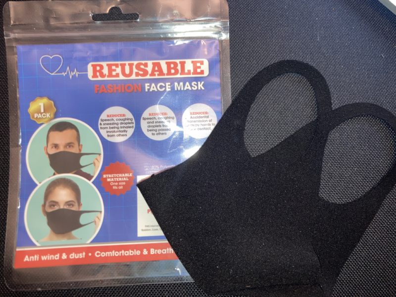 a black face mask and a package of face masks