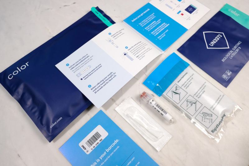 a blue and white package with a label and a syringe