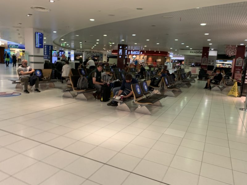 people sitting in a row of benches