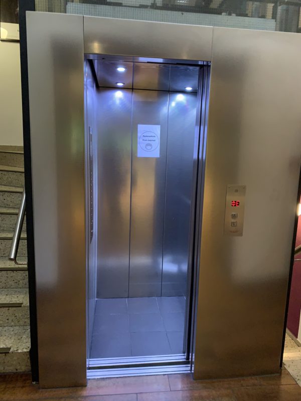 an elevator with a sign on the door