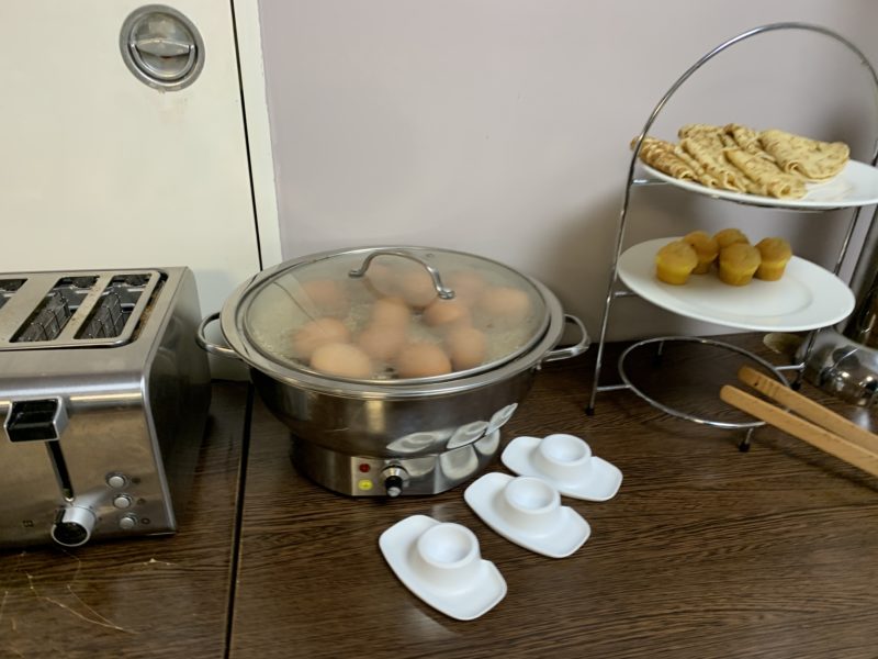 a kitchen counter with a toaster and a pot of eggs