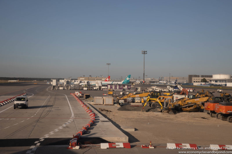 a construction site with airplanes and trucks