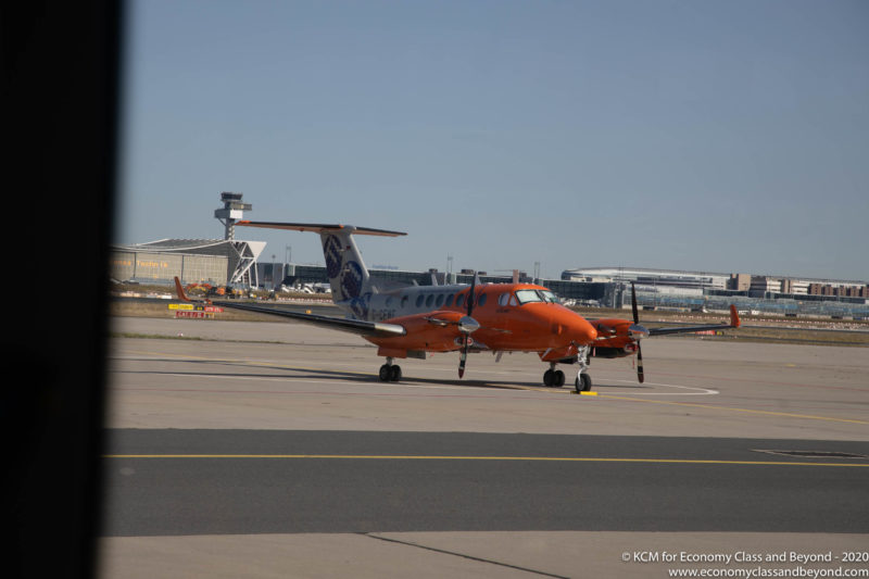 an orange airplane on a runway