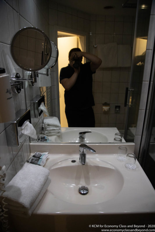 a man taking a picture of himself in a bathroom