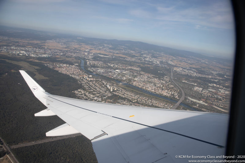 an airplane wing and a city