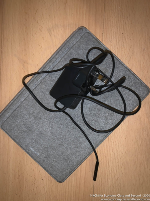 a black device with wires on a grey surface