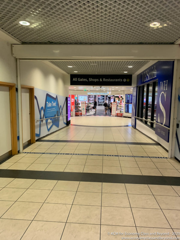 a hallway with signs and people walking