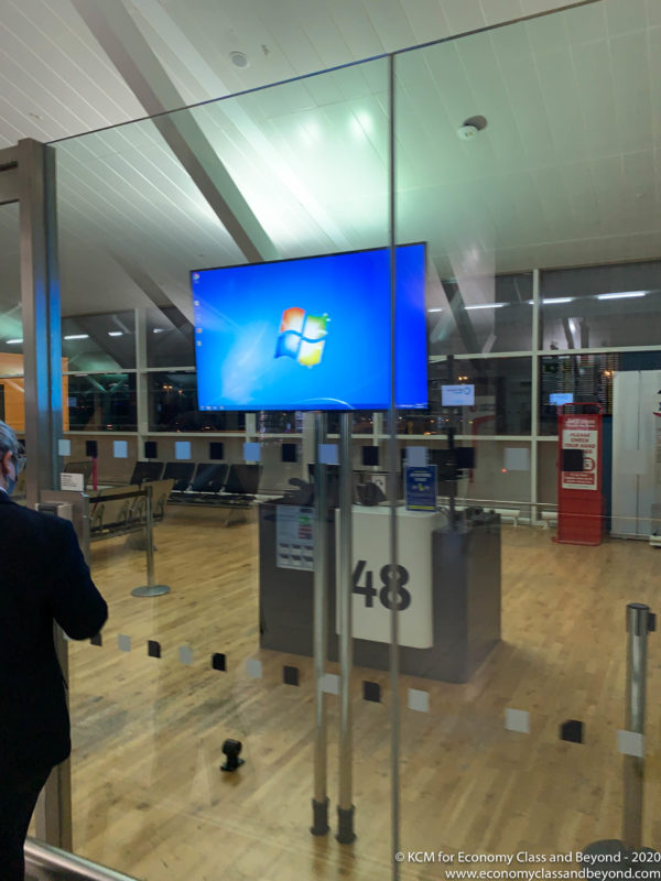 a man looking at a screen in an airport