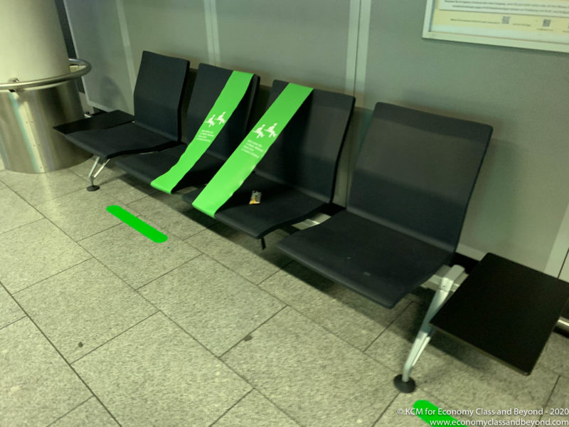 a row of black chairs with green labels