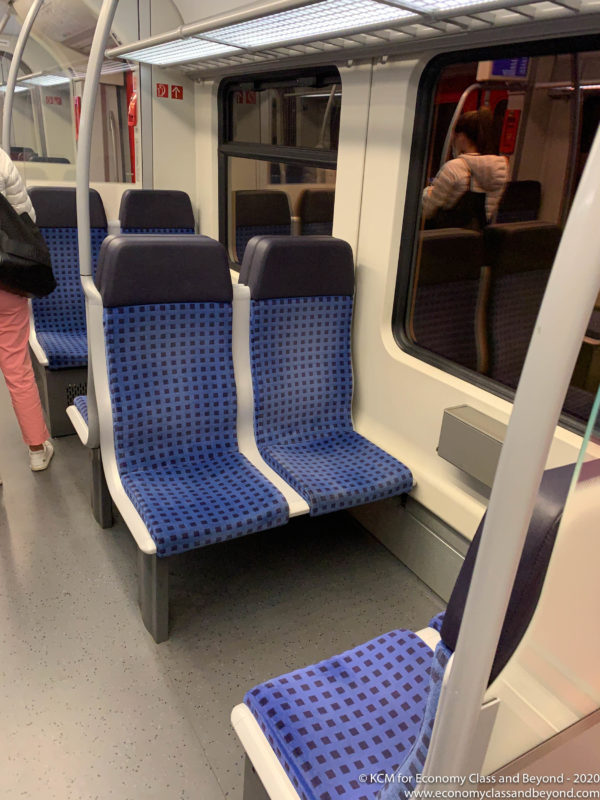 a blue and white seats on a train