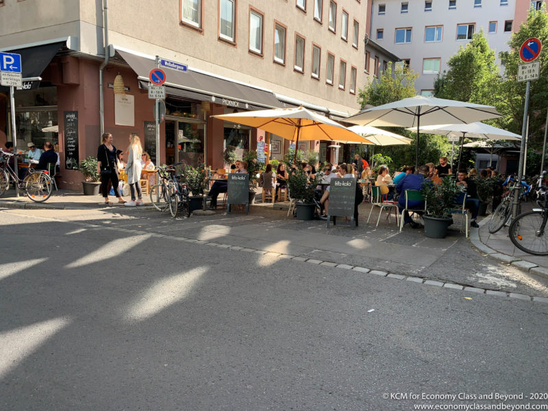 a group of people sitting outside a restaurant