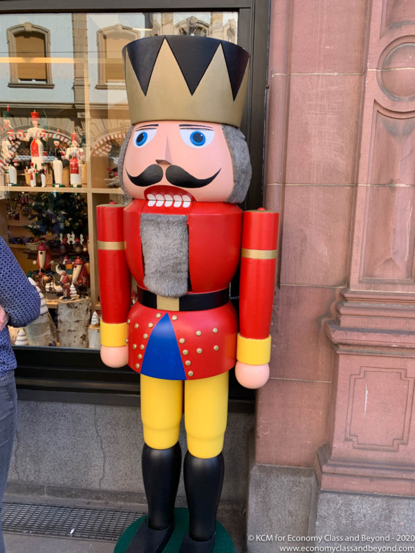 a large wooden nutcracker in front of a store