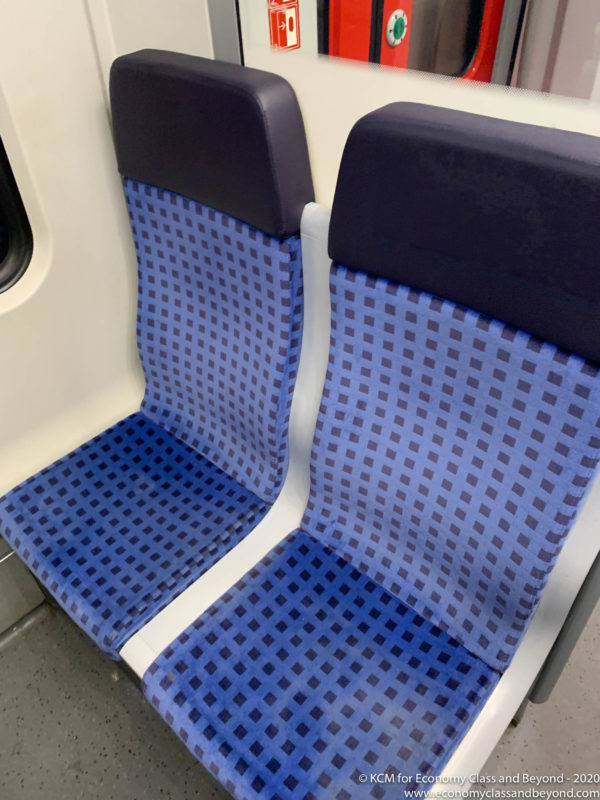 blue and black seats on a train