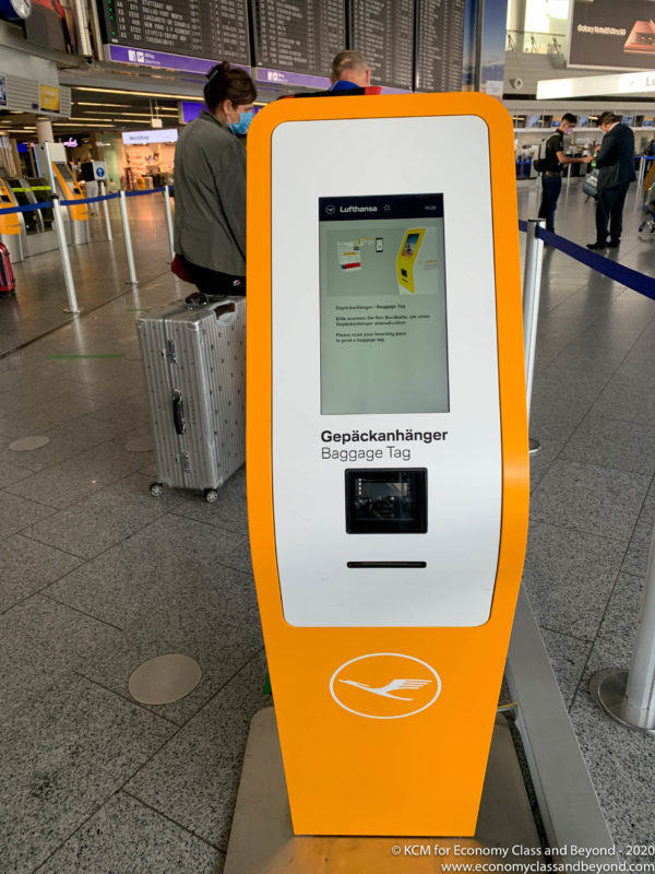 an orange and white machine in a airport