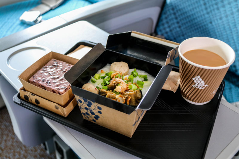 food in a box with a drink on a tray