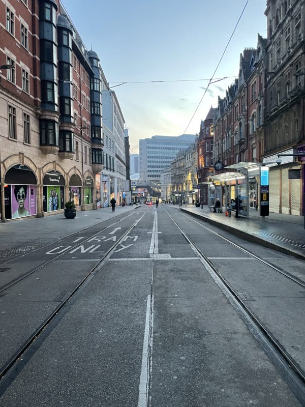 a street with buildings and a tram track