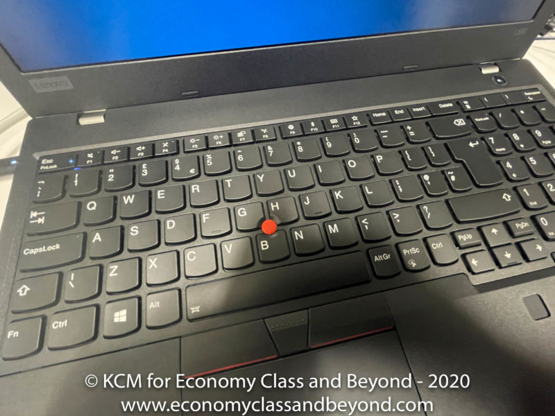 a black laptop with a red dot on it