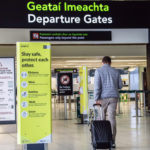 a man pulling a suitcase in an airport