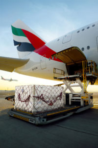 a plane loading cargo onto a truck