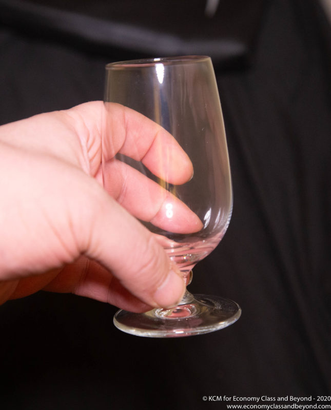 a hand holding a clear glass