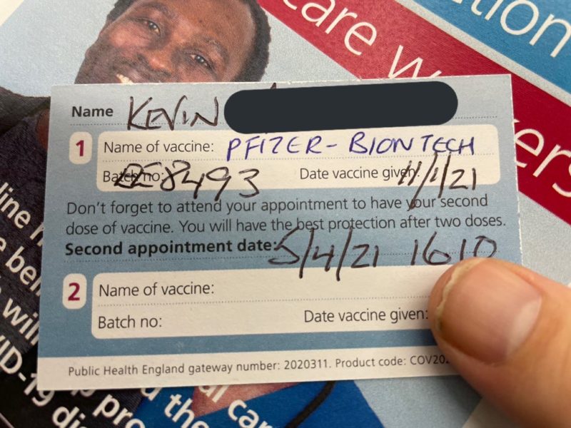 a person holding a vaccine card