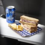 a sandwich and a can of beer