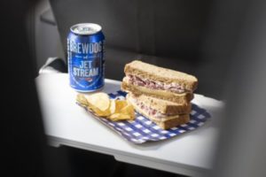 a sandwich and a can of beer