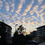 a group of buildings with clouds in the sky