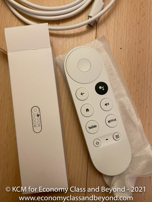 a remote control and box on a wood surface