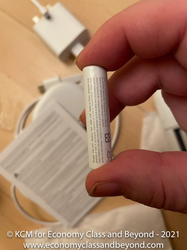 a hand holding a white battery