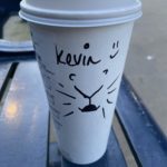 a coffee cup with a drawing on it