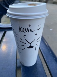 a coffee cup with a drawing on it