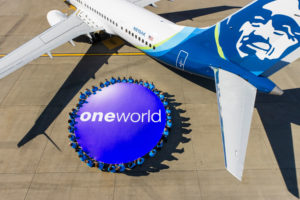a group of people around a circle of blue and white text on a plane