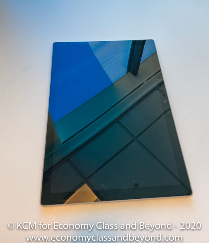 a rectangular tablet with a reflection of a building