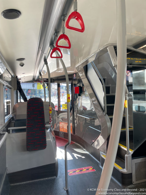 a bus with red handles and seats
