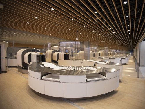 a large airport terminal with luggage conveyor belt