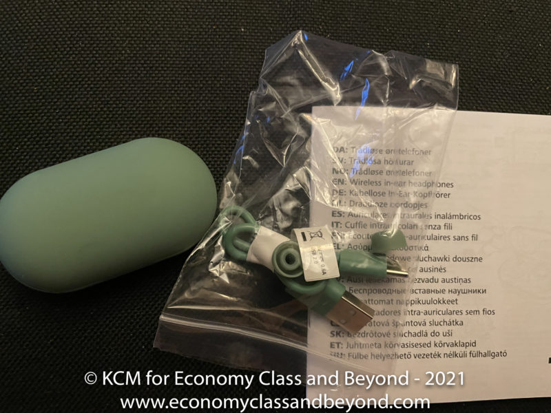 a green usb cable in a plastic bag next to a piece of paper