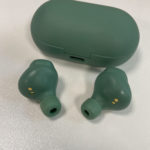 a green ear buds and a case