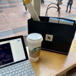 a laptop and coffee bag on a table