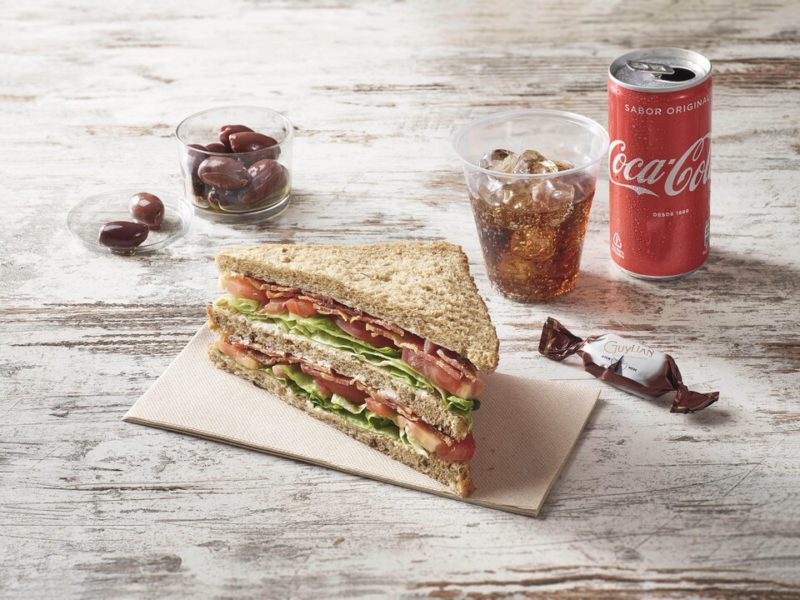 a sandwich and a soda on a table